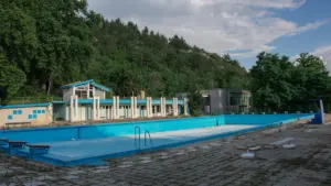 Vue d'ensemble de la piscine municipale extérieure entourée par la végétation